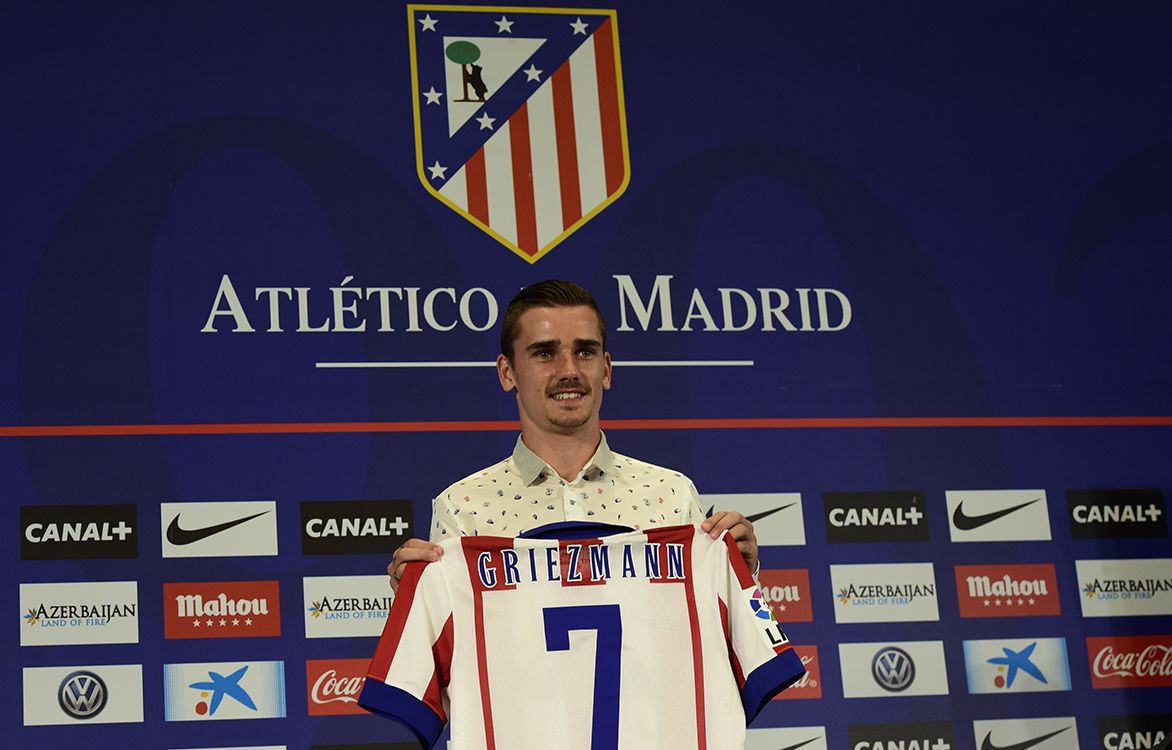 France international and new Atletico de Madrids forward Antoine Griezmann poses with his new jersey during his presentation at the Vicente Calderon stadium in Madrid on July 31, 2014. Griezmann, 23, had been linked with several clubs around Europe, including Premier League side Tottenham Hotspur, but Atletico, who claimed their first Spanish league title in 18 years last season, have won the race for the French winger.     AFP PHOTO/ JAVIER SORIANO (Photo by JAVIER SORIANO / AFP)
