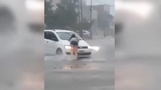 Video: un hombre se llevó puesta a una chica sobre el capó de su auto en medio del temporal